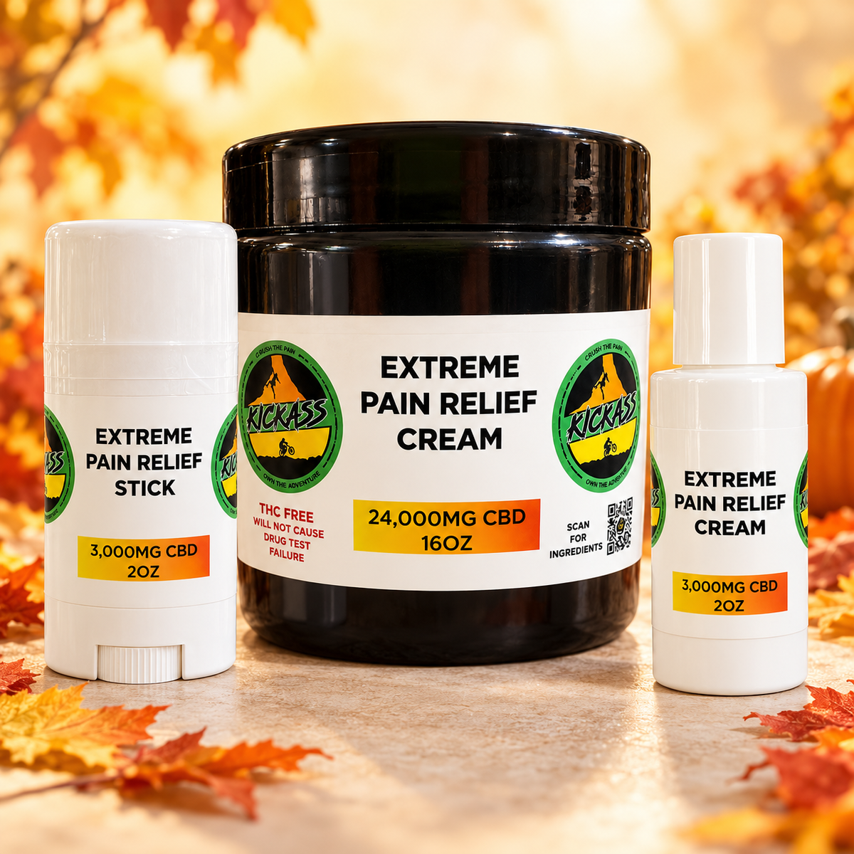 KickAss Fall Relief Bundle with 16 oz cream, 3,000mg Sports Stick, and 2 oz travel cream in a bright autumn setting